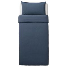 a bed with blue sheets and pillows on it