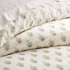 three pillows stacked on top of each other next to a white bed sheet and pillowcase