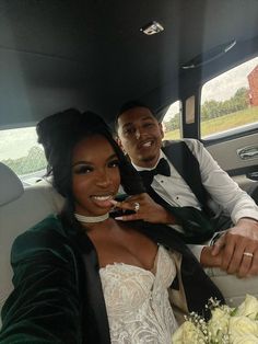 a bride and groom sitting in the back seat of a car, smiling at the camera