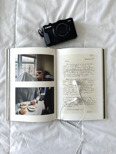 an open book with photos and a camera