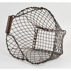 a wire basket with a wooden handle on it