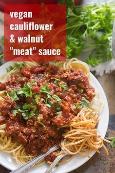 a white plate topped with spaghetti and meat sauce