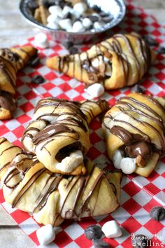 chocolate covered pastries on a red and white checkered tablecloth with marshmallows