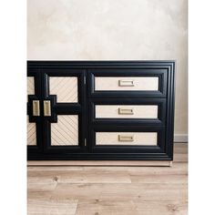 a black and white dresser with gold handles