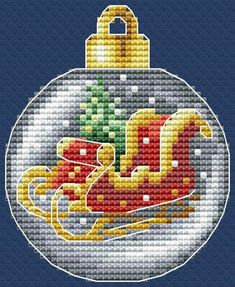 a cross stitch christmas ornament with a sleigh