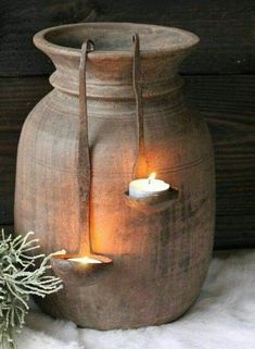 a candle is lit in a clay pot