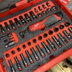 an assortment of tools in a red case