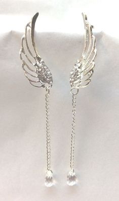 "Elegant, Beautiful Earrings, Dangle Style. All Occasion Piece, Very Exquisite Long Dangle Angel Wings Design with Rhinestone Accents and Chain. Ear cuff at top to hold them in place. Silver Tone. Approx. Size 4\" long" Gold Angel Wing Earrings, Angel Wing Accessories, Angel Wing Jewelry, Angelic Accessories, Elegant Earrings Silver, Chain Ear Cuff, Angel Accessories, Wings Jewelry, Wedding Angels