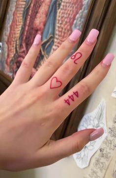 a woman's hand with two finger tattoos on it