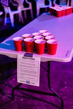 a table with red cups on it and a sign that says beer pong next to it