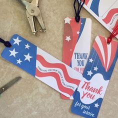 patriotic thank you tags with scissors and other items on the table next to each other