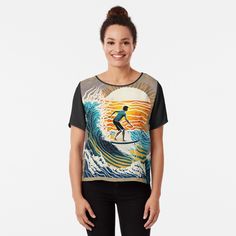 a woman standing on top of a surfboard in front of an ocean wave with a surfer