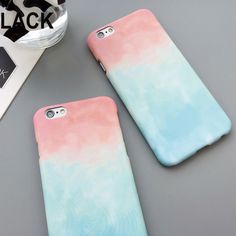 two phone cases sitting next to each other on top of a table with a cell phone case