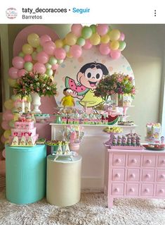 a table with balloons, cake and decorations for a minnie mouse birthday party on it