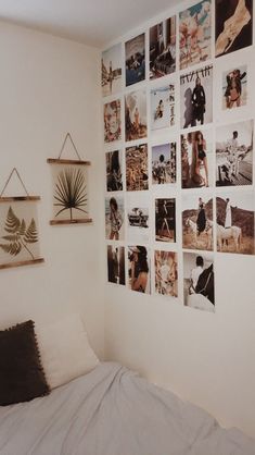 a bed sitting in a bedroom next to a wall with pictures on it