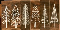 four wooden christmas trees are on display