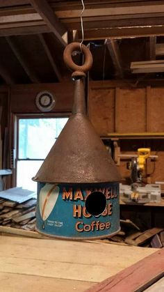 a bird house hanging from the ceiling in a workshop