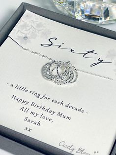 a birthday card with a silver necklace on it