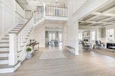 a large open floor plan with stairs leading up to the second story