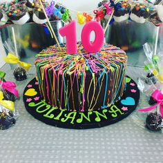 a birthday cake with the number ten on it surrounded by candy and candies,