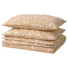 three pillows stacked on top of each other in front of a white background with paisley print