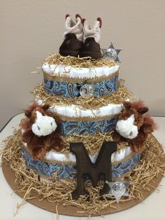 a three tiered cake decorated with teddy bears and other items on top of it