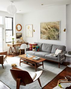 a living room filled with furniture and lots of windows