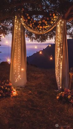 an outdoor wedding set up with string lights