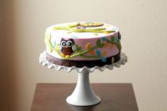 a decorated cake sitting on top of a wooden table