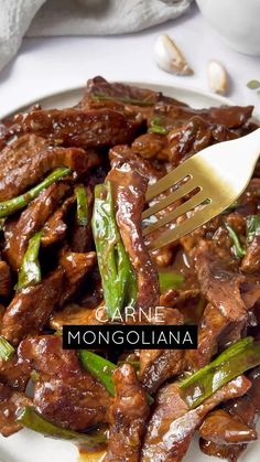 a white plate topped with meat and asparagus