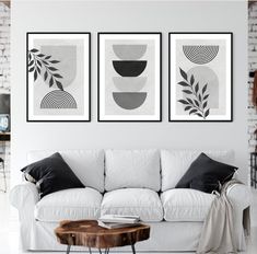 three black and white art prints hanging on the wall above a couch in a living room