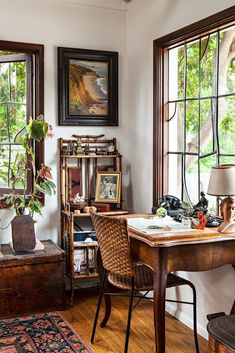 a room with a desk, chair and bookshelf