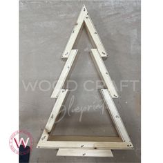 the wooden triangle is being assembled to be used as a wall hanging or display piece