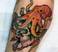 an octopus and skull tattoo on the leg