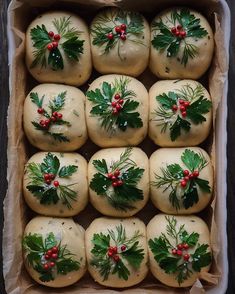 christmas sprigs and holly decorated cookies in a box