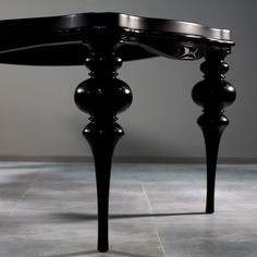 a black table sitting on top of a tiled floor