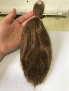 someone is cutting the ends of their hair