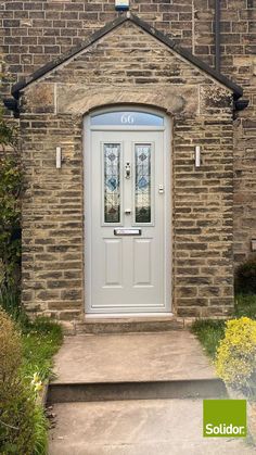 the front door to a brick building with two stained glass windows