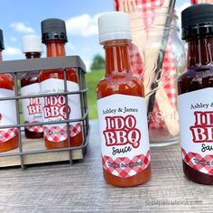 three bottles of bbq sauce sitting on a table