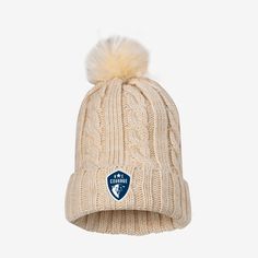 a white knitted hat with a blue and white logo on the front, featuring a pom - pom