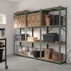 a room filled with lots of shelves and boxes on top of each shelf, next to a bike