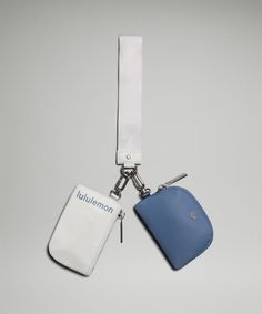 two blue and white luggage tags attached to a lanyard keychain on a gray background