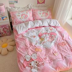 a pink hello kitty bed set with matching comforter and pillow cases in a girls bedroom