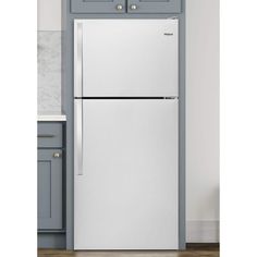 a white refrigerator freezer sitting inside of a kitchen