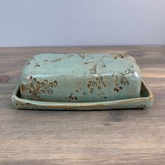 a ceramic dish sitting on top of a wooden table