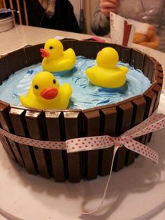 three rubber ducks in a bathtub on a table