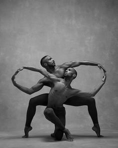 two men in black and white pose for the camera with their arms around each other