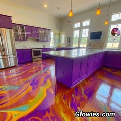 a kitchen with purple and orange paint on the floor