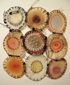 a group of different colored plates sitting on top of a white wall