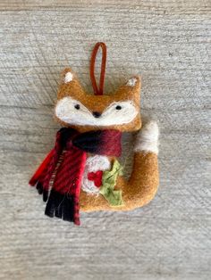 an ornament shaped like a fox with a scarf around it's neck